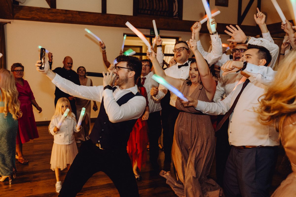DJ na parkiecie z telefonem podczas wesela i szalony blok muzyczny